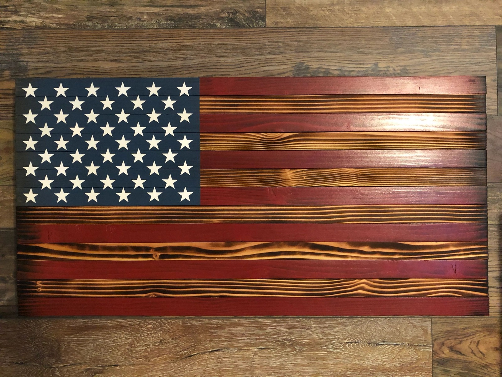 Handmade wooden American flag with charred-wood stripes