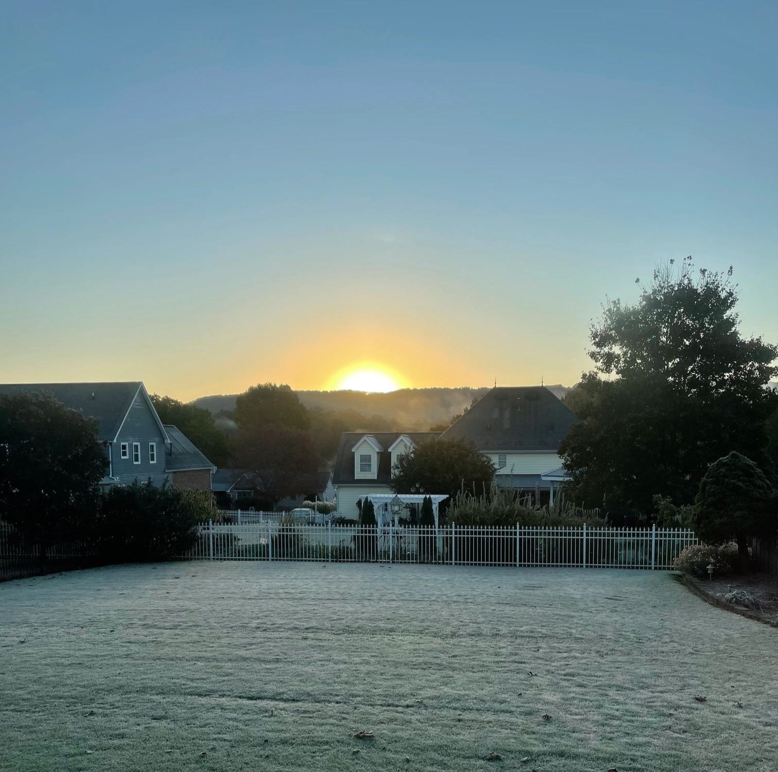 The sun rising from behind the clouds